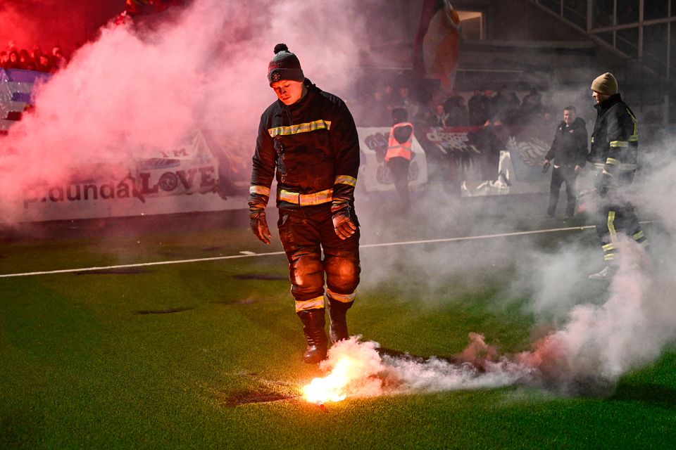 Fire stewards remove flares from the pitch before the SSE Airtricity Men's Premier Division match between Dundalk and Drogheda United at Oriel Park. Photo: Ben McShane/Sportsfile